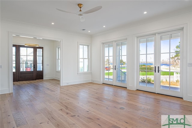 doorway to outside with french doors, light wood-type flooring, recessed lighting, and crown molding