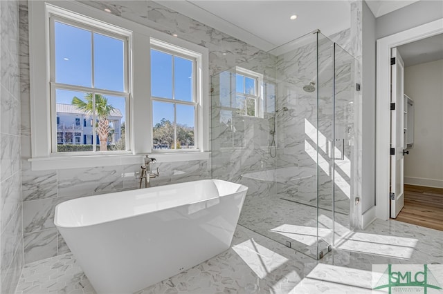 full bath featuring recessed lighting, marble finish floor, a freestanding bath, and a marble finish shower