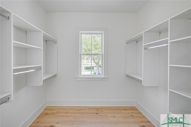 walk in closet with hardwood / wood-style floors