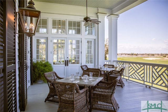 sunroom featuring a ceiling fan, french doors, plenty of natural light, and decorative columns