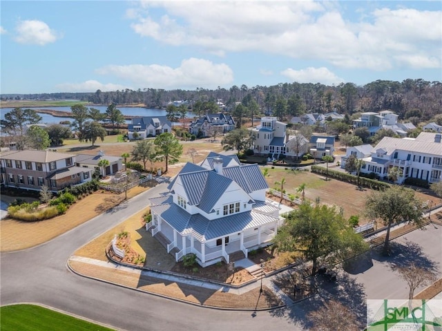 drone / aerial view featuring a water view and a residential view