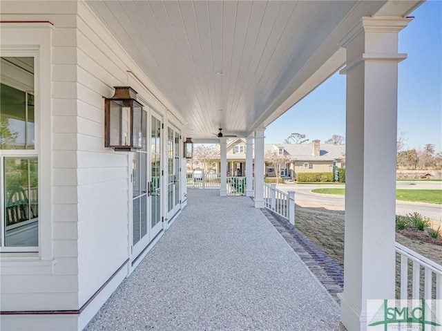 view of patio with covered porch, french doors, and a residential view