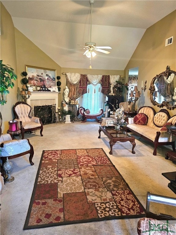 living room with vaulted ceiling, carpet flooring, and ceiling fan