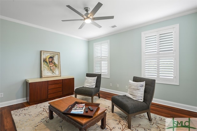 sitting room with ornamental molding, dark hardwood / wood-style floors, and ceiling fan