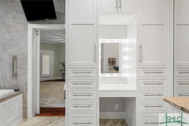 interior space with vanity and ornamental molding