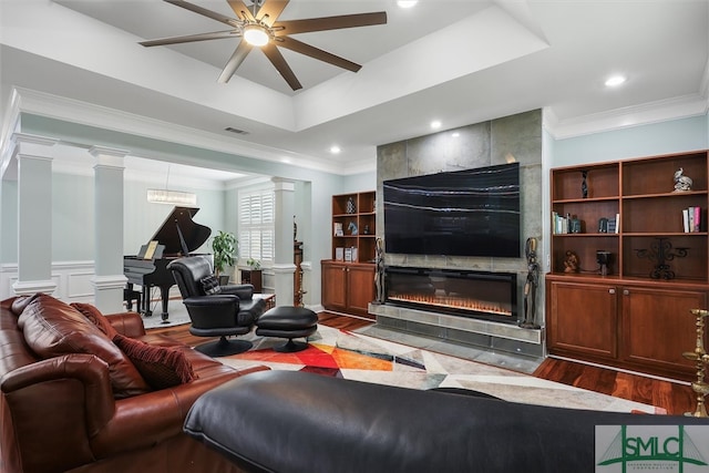 living room with ornamental molding, dark hardwood / wood-style floors, ornate columns, and ceiling fan