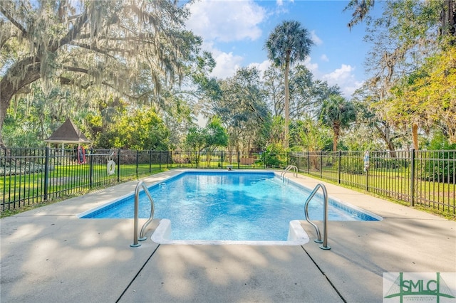 view of pool featuring a lawn