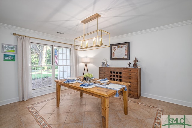 dining space with an inviting chandelier, crown molding, and light tile patterned floors