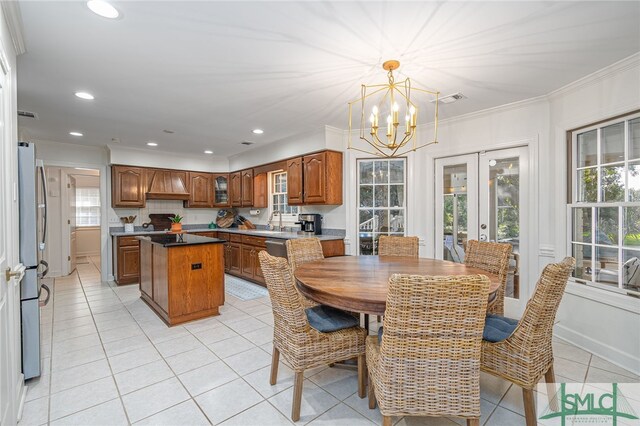 70 Marsh Creek Ln, Richmond Hill, GA 31324 - dining room with visible vents, crown molding, french doors, light tile patterned floors, and a notable chandelier