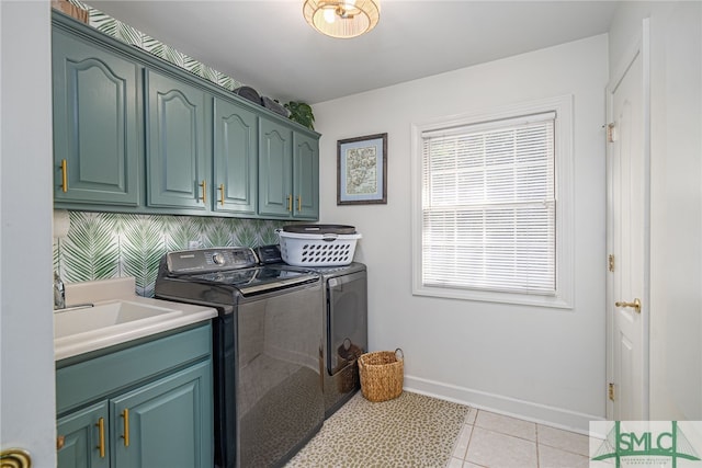 laundry area with sink, light tile patterned flooring, separate washer and dryer, and cabinets