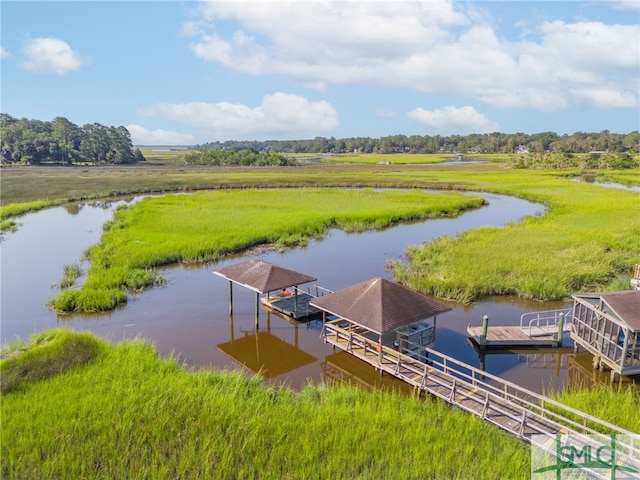 dock area with a rural view and a water view