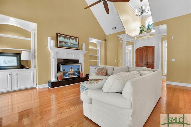 living room with ornamental molding, light hardwood / wood-style flooring, high vaulted ceiling, and ceiling fan