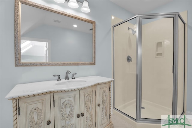 bathroom featuring vanity and a shower with shower door