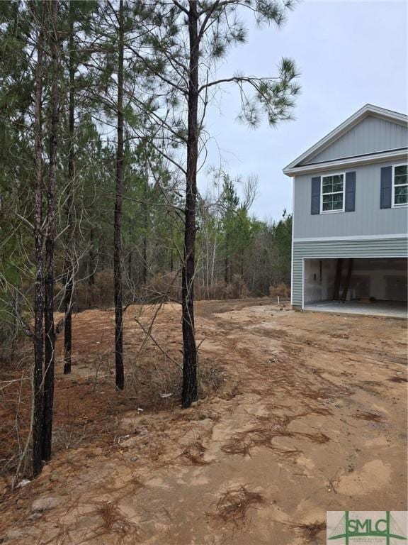 view of side of home with a carport