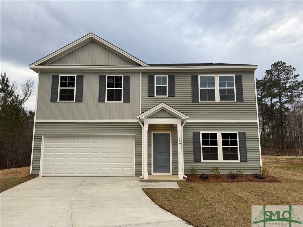 traditional home with driveway and an attached garage