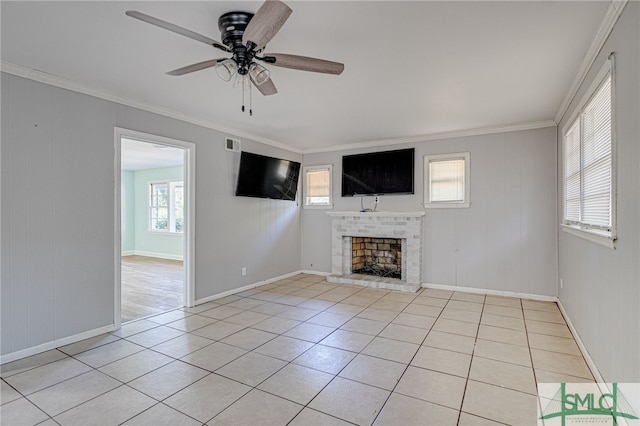 unfurnished living room featuring ornamental molding, ceiling fan, light tile patterned flooring, and a brick fireplace