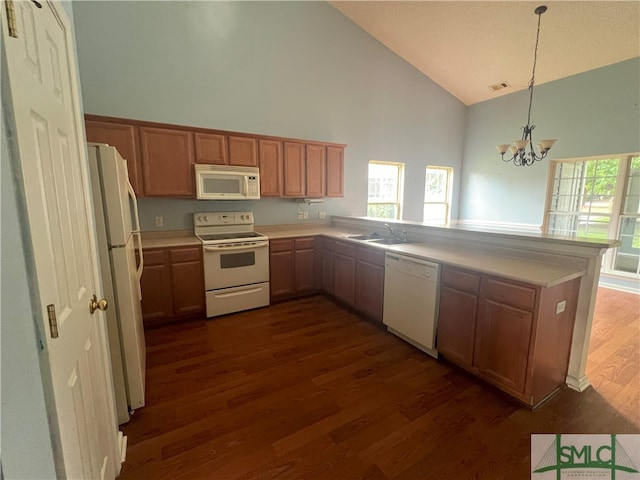 kitchen featuring dark hardwood / wood-style floors, hanging light fixtures, white appliances, kitchen peninsula, and high vaulted ceiling