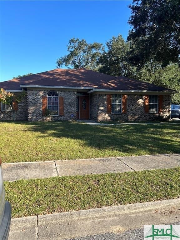 ranch-style home featuring a front lawn