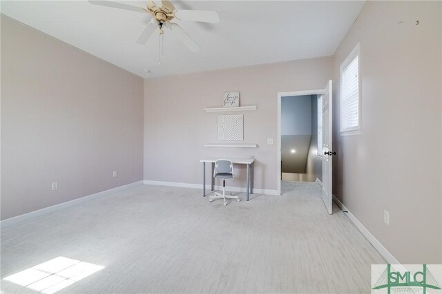 spare room featuring light carpet and ceiling fan