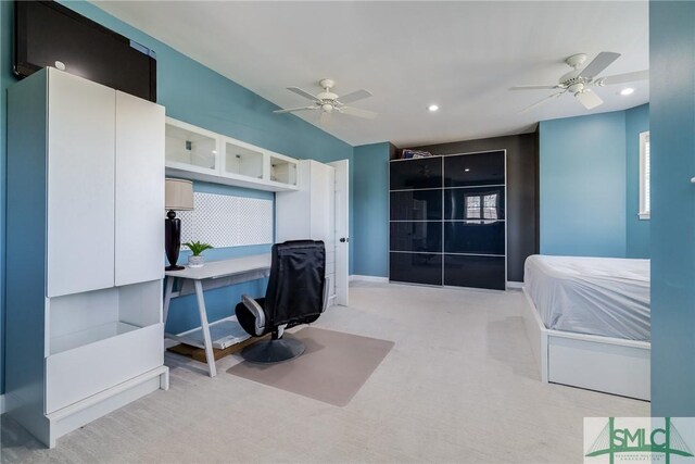 office space with light colored carpet and ceiling fan