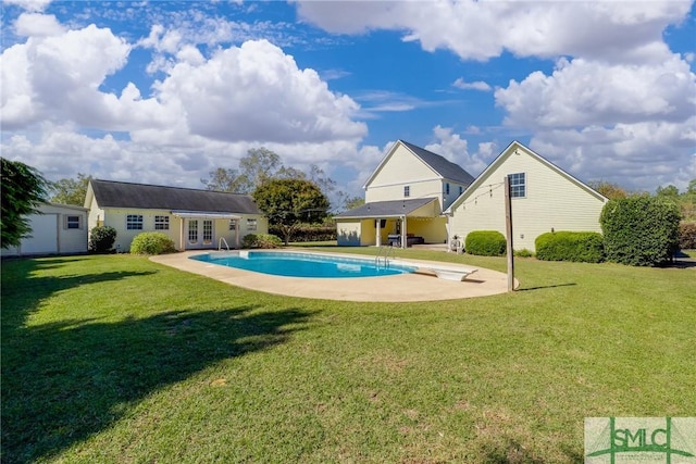 view of swimming pool featuring a patio, an outdoor structure, and a lawn