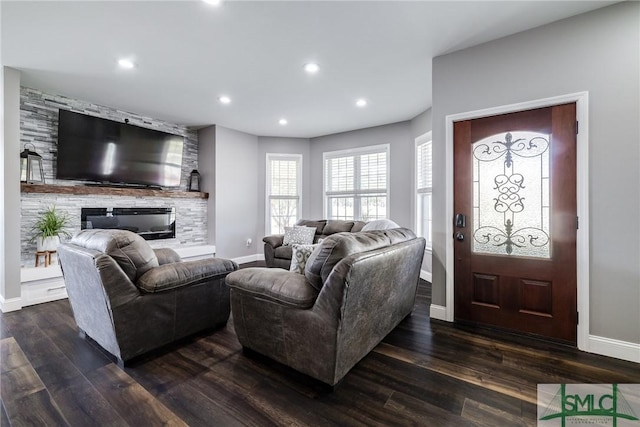 living room with dark hardwood / wood-style floors and a fireplace