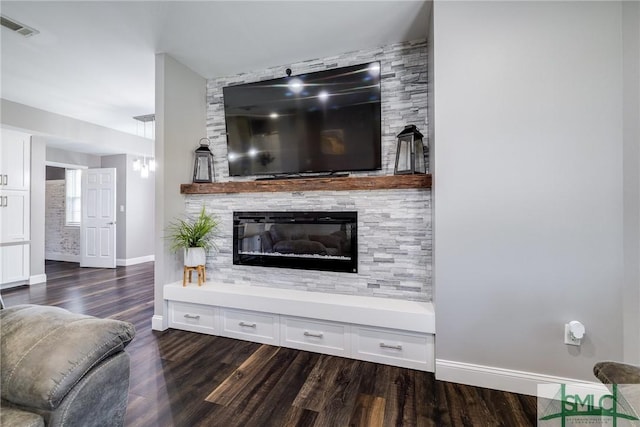 living room with a fireplace and dark hardwood / wood-style flooring