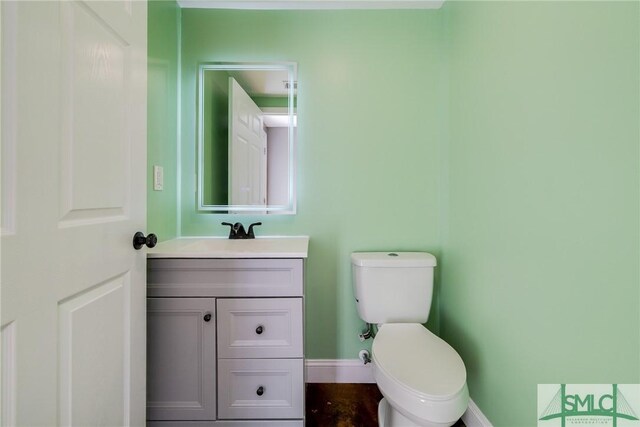 bathroom featuring vanity and toilet