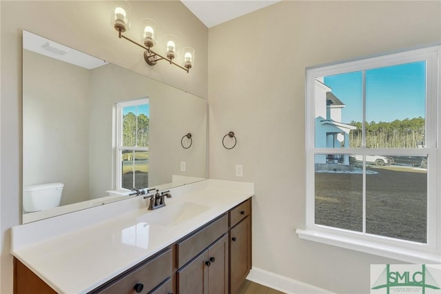 bathroom with vanity and toilet