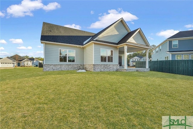 back of house featuring a yard