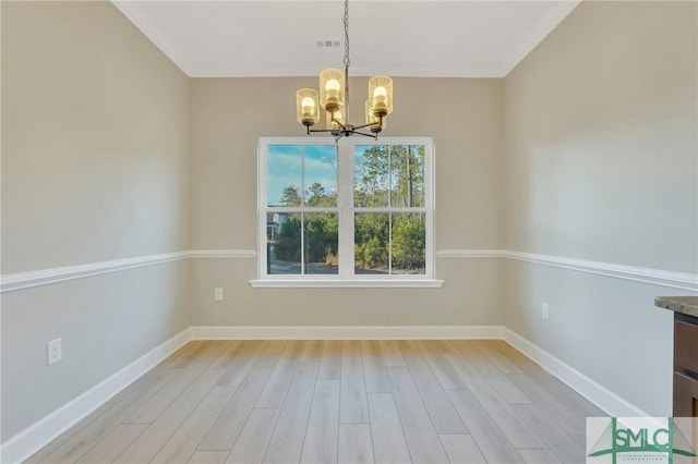 unfurnished dining area with ornamental molding, a chandelier, and light hardwood / wood-style floors