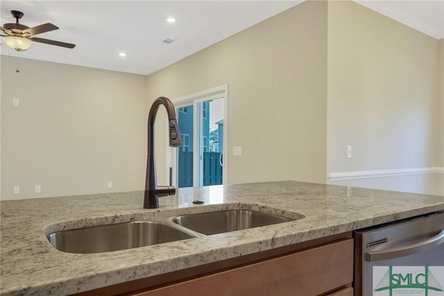 kitchen featuring dishwasher, light stone countertops, sink, and ceiling fan