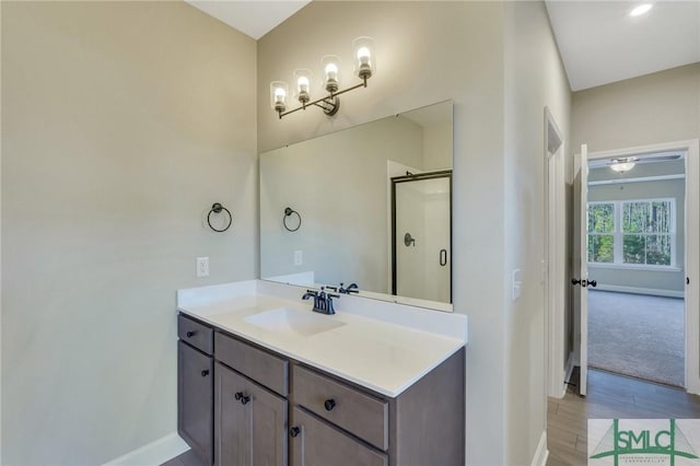 bathroom featuring vanity, hardwood / wood-style floors, and walk in shower