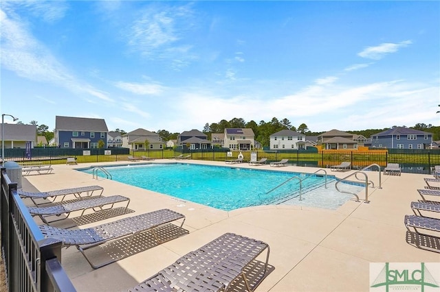 129 Hanover Pl, Richmond Hill, GA 31324 - community pool with a patio, a residential view, and fence