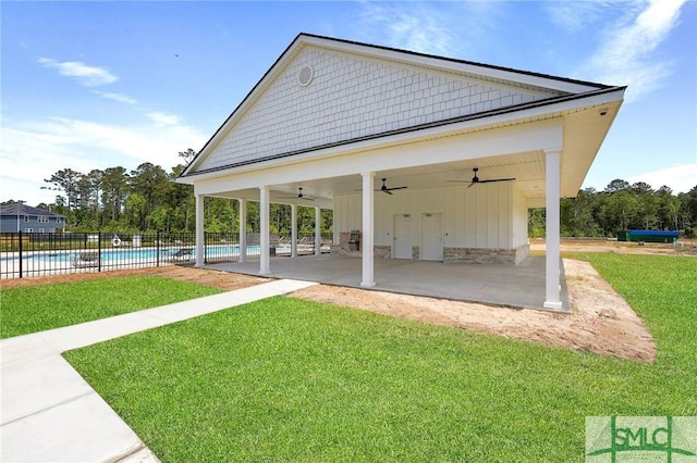 129 Hanover Pl, Richmond Hill, GA 31324 - view of property's community featuring a pool, a patio, fence, and a lawn