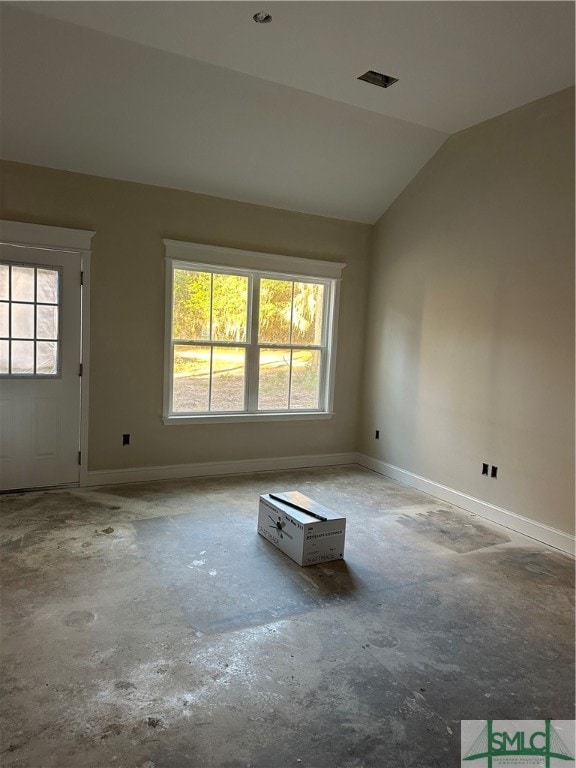 spare room with vaulted ceiling