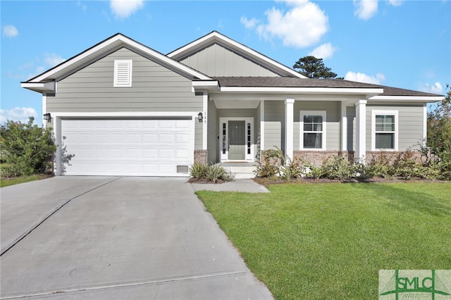 view of front of house featuring a front yard and a garage