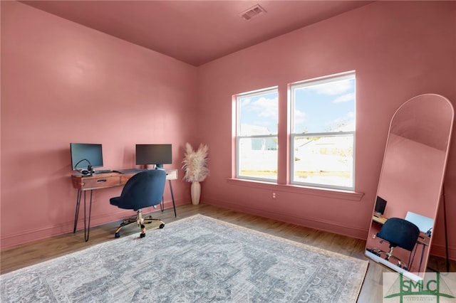 home office with light hardwood / wood-style floors