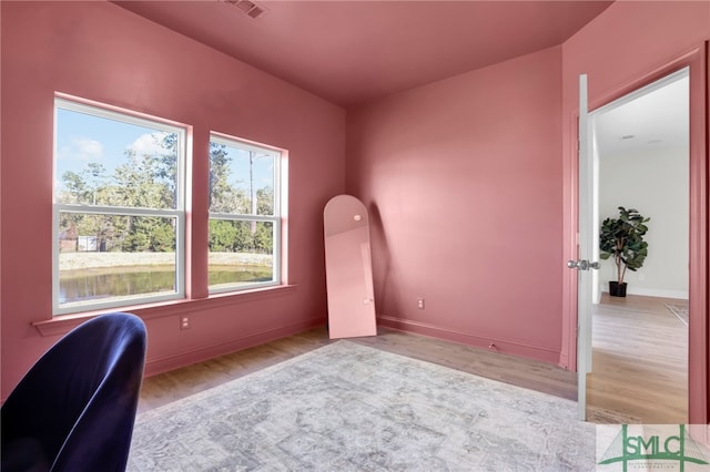 home office with light hardwood / wood-style flooring