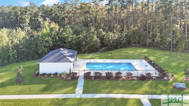 view of pool with a yard