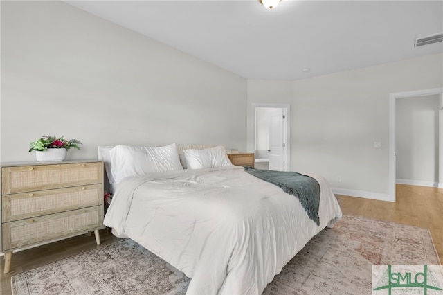 bedroom with hardwood / wood-style flooring