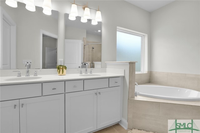 bathroom with vanity, tile patterned floors, and separate shower and tub