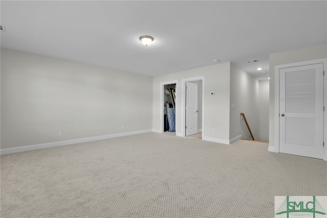 spare room featuring light colored carpet