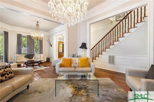 living room featuring crown molding, dark hardwood / wood-style flooring, and a chandelier