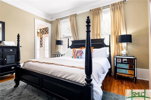 bedroom featuring hardwood / wood-style flooring and crown molding