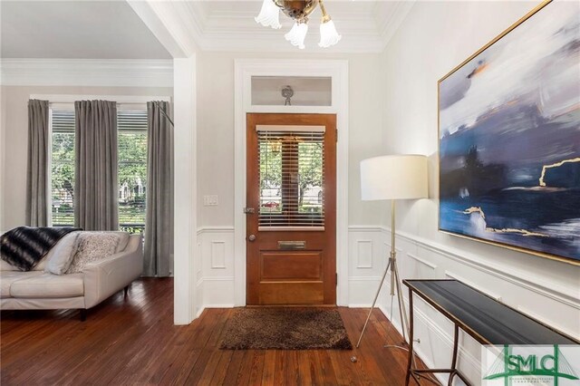 foyer featuring crown molding and dark wood-type flooring