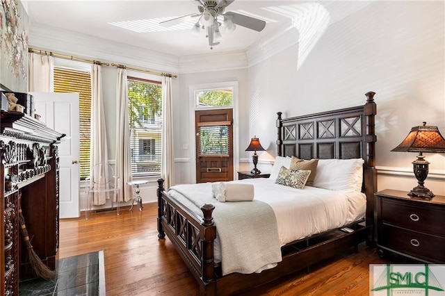 bedroom with ceiling fan, ornamental molding, and hardwood / wood-style floors