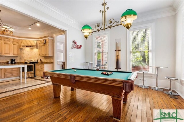 rec room with billiards, ornamental molding, light hardwood / wood-style floors, and track lighting