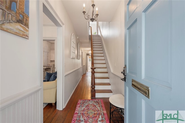 entrance foyer featuring a chandelier and dark hardwood / wood-style flooring