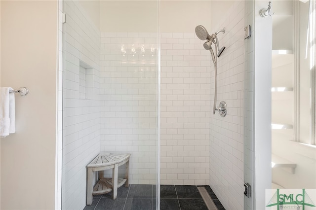 bathroom with a shower with door and tile patterned floors